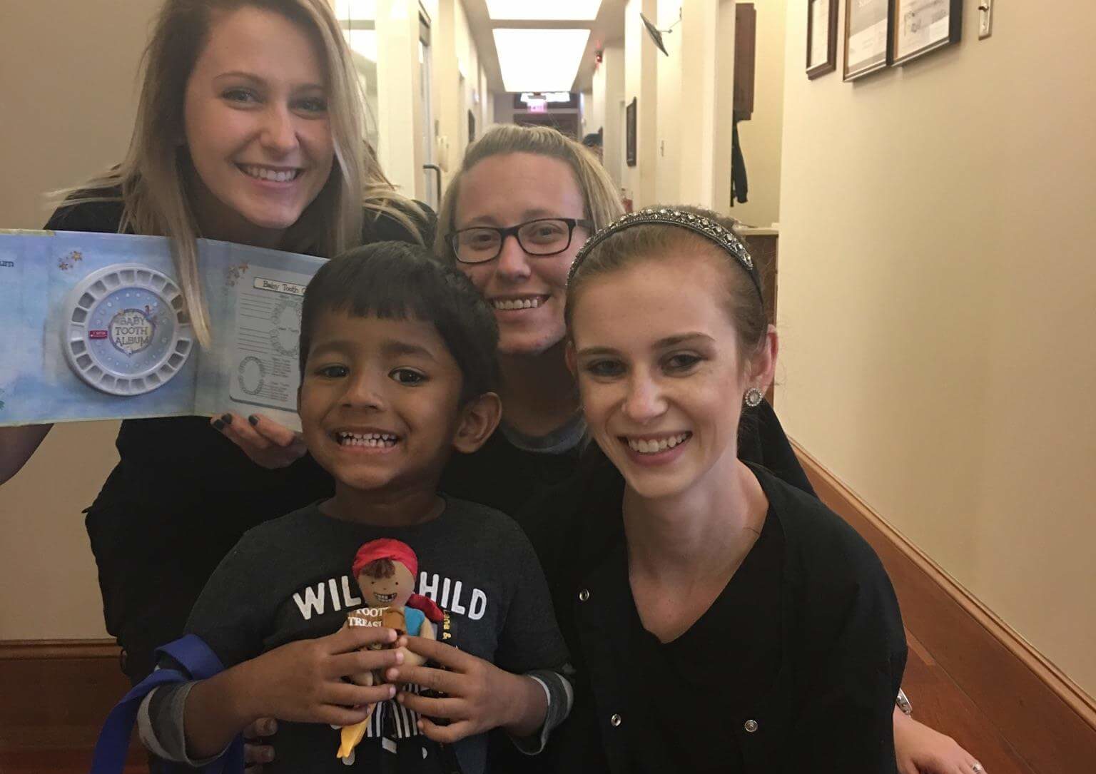 team-with-child-first-dental-visit-e1541622172526